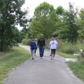 man and woman walking paved path at Oak Creek South Park