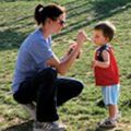 mom feeding toddler son Kona Ice at Family Recess