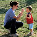 mom feeding toddler son Kona Ice at Family Recess