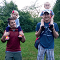2 men with small children on shoulders