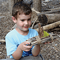 child building a boat at the Nature Playce