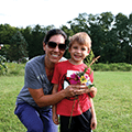 mother and son holding a bouquet of wildflowers