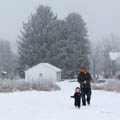 father and toddler walking in snow at Bill Yeck Park Smith House