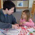 CWPD employee crafting with preschool aged girl