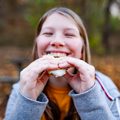 teenage girl eating s'more