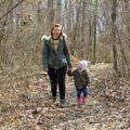 woman and young girl walking on wooded trail