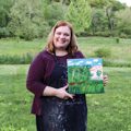 woman holding painting of Grant Park