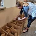 female volunteer filling paper bags
