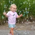 young girl surrounded by bubbles