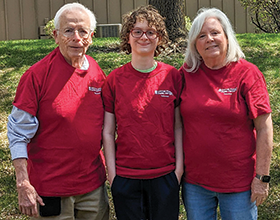 three people in matching red t-shirts