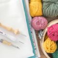 needle punch tools and yarn on a table