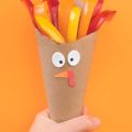 brown paper in a cone shape holding sliced peppers to look like a turkey