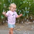 little girl chasing bubbles