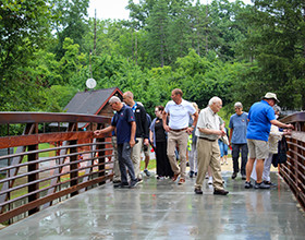 people walking across a bridge