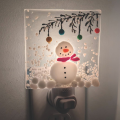 glass fused night light with a snowman image on it
