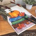 watercolor painting of an orange pumpkin stacked on top of colorful fall sweaters with fall leaves