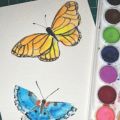 watercolor painting of two butterflies with a paint palate off to the right side