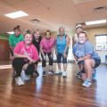 a group of women posing together after a workout