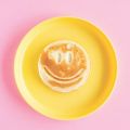smiley face waffle on a yellow plate