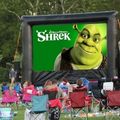 inflatable outdoor movie in a park featuring shrek