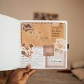 a handheld journal filled with paper scraps
