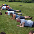 Multiple people hold a plank position during an exercise class.