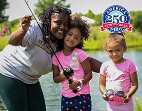 A woman and two young girls holding a fishing pole. A pond is in the background. American 250-Ohio logo is on the photo.