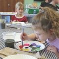 young girl painting at an Art & Imagination program