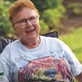 a woman sitting in a chair and smiling