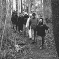 a black and white photo of a group of hikers in the woods