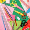 scissors construction paper and craft supplies laid out on a table