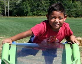 Boy playing on Robert F. Mays Park playground
