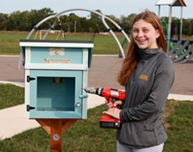 Lauren Shenk installs Little Free Library at Robert F. Mays Park