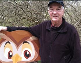Tom McGavick with Owlexander sign