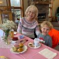a grandmother and grandson at a tea party